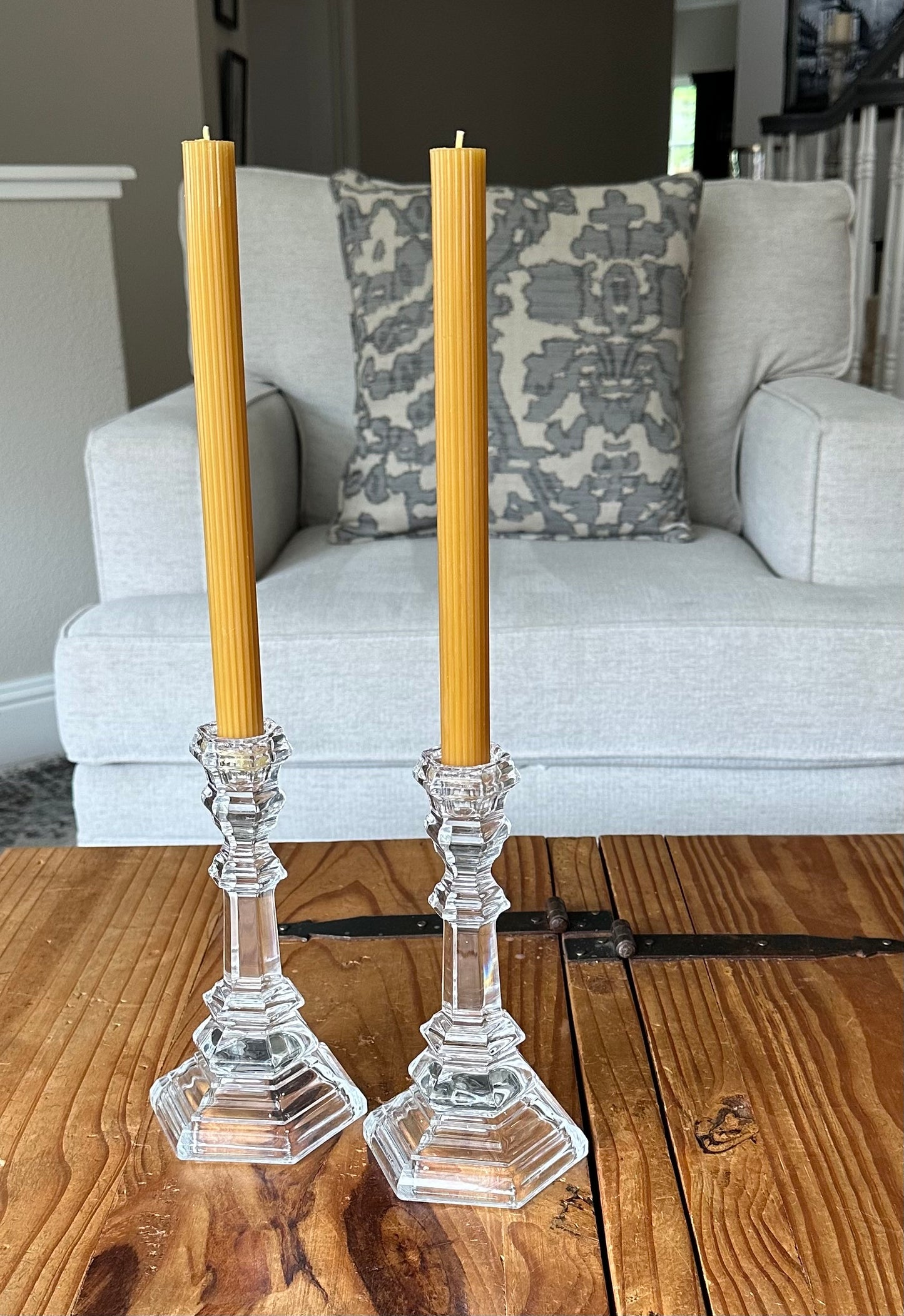 Ribbed Taper Dinner candles in natural beeswax on a rustic wooden table